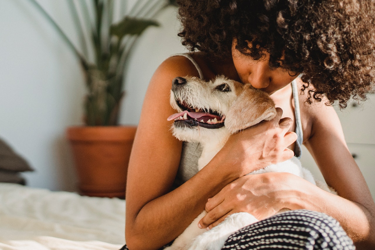 woman kissing dog